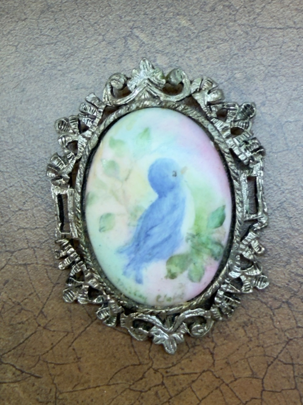 Hand-Painted Blue Bird Porcelain Brooch with Ornate Silver Frame